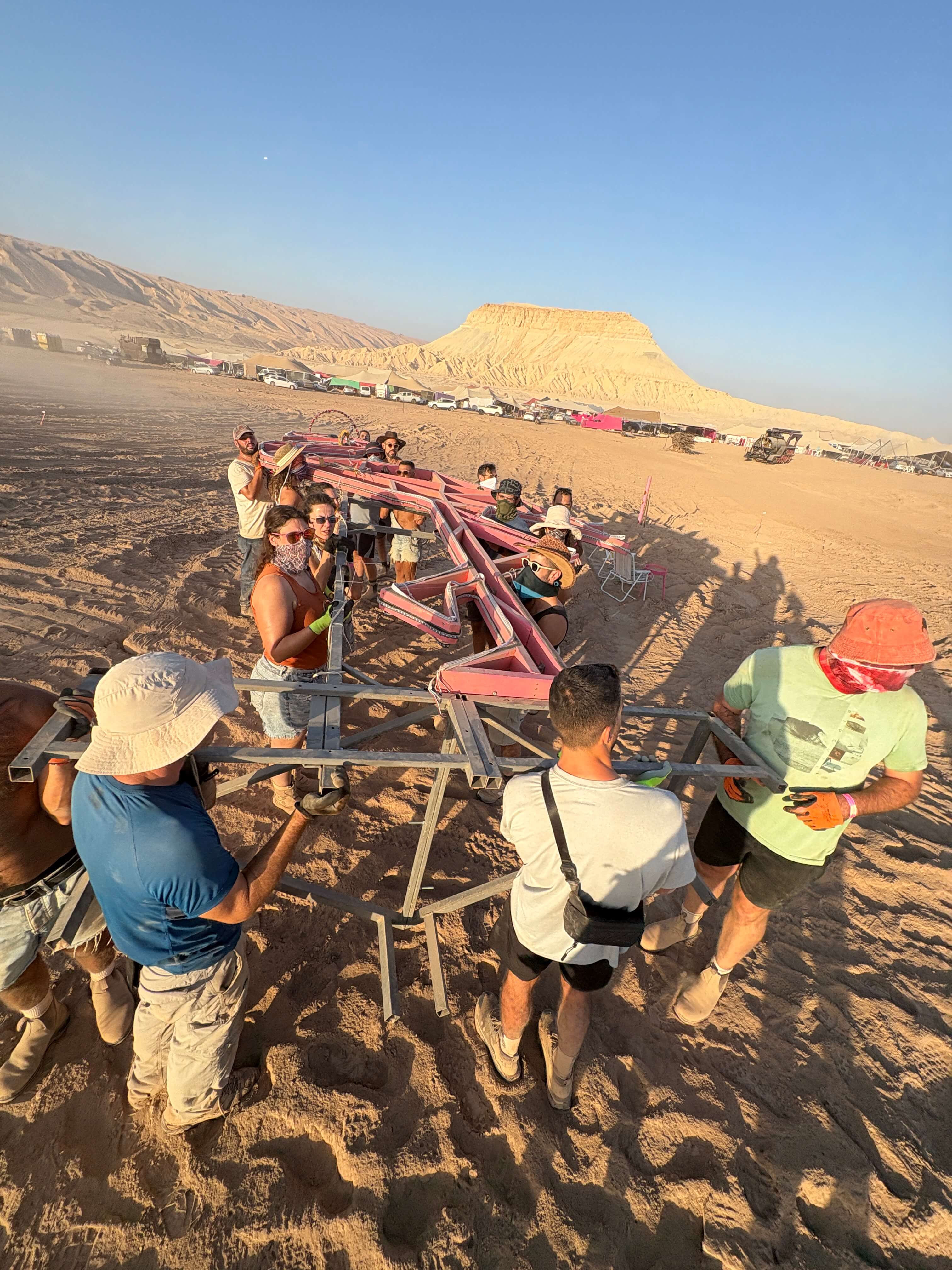 Carrying the steel frame across the playa at Midburn